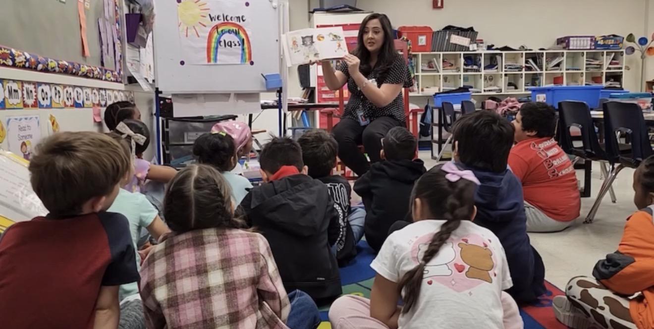 Meredith reading to a group of children